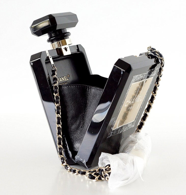 Limited Edition sold out CHANEL perfume bottle bag in black plexi glass!
This fabulous piece is worn as a clutch or shoulder.
The absolute timeless essence of CHANEL!
Black leather interior.
Signature CHANEL stamp inside the bag. 
Serial number