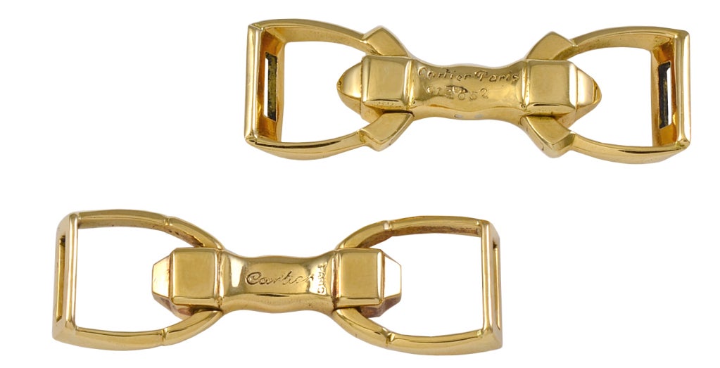 Masculine 18k gold stirrup cufflinks, made, signed and numbered by Cartier France. An excellent flip-up mechanism, very easy to put on.  A crisp elegant look. Fine French Deco.
.