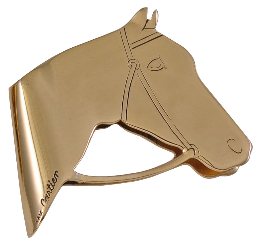 Figural 14k double-sided horse-head money clip made by Cartier. 
A rare subject, very appealing.