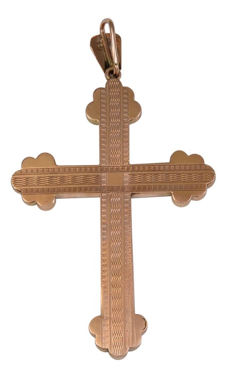 Very unusual and attractive large antique cross. All over intricately- engraved cross with black tracery enamel.Set in 10K yellow gold. 2 1/2