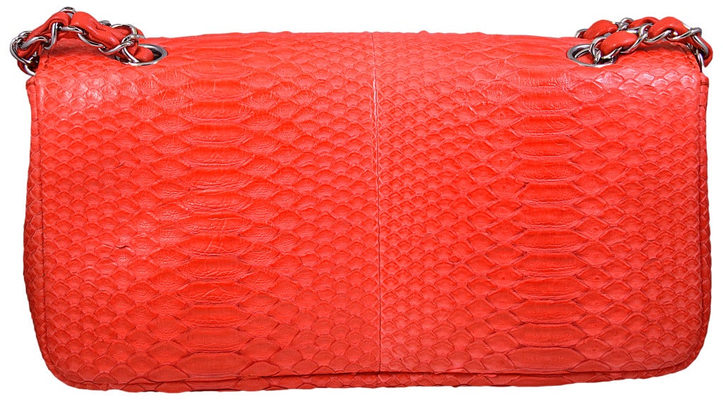 Classic Chanel orange python bag. This bag has never been used. It was purchased in New York ten years ago, the only orange python bag produced for the New York  market that season . This is a rare vibrant color.They still make a similar bag, but it