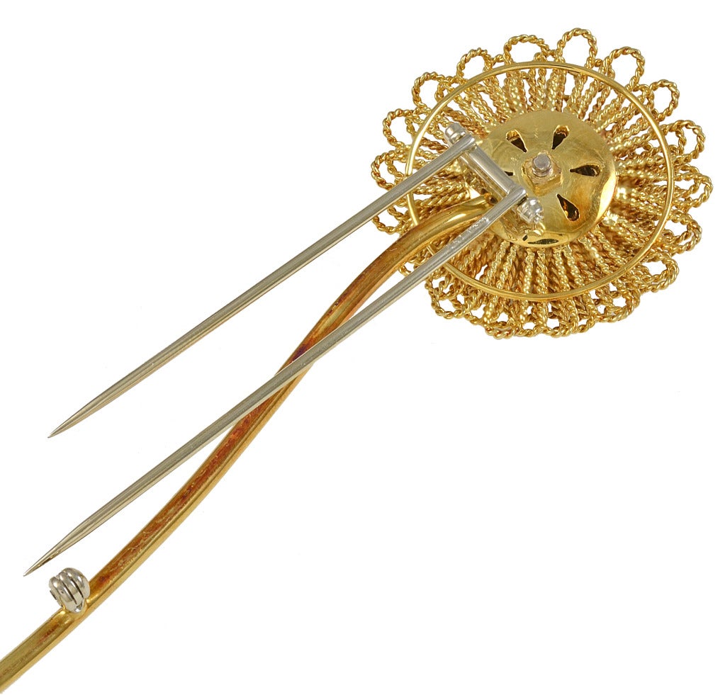 Very large figural flower clip. Comprised of 18K gold lacey scalloped loops. Centered with 1.10cts of brilliant pave diamonds. Set on a long graceful stem.
This outstanding clip is 5