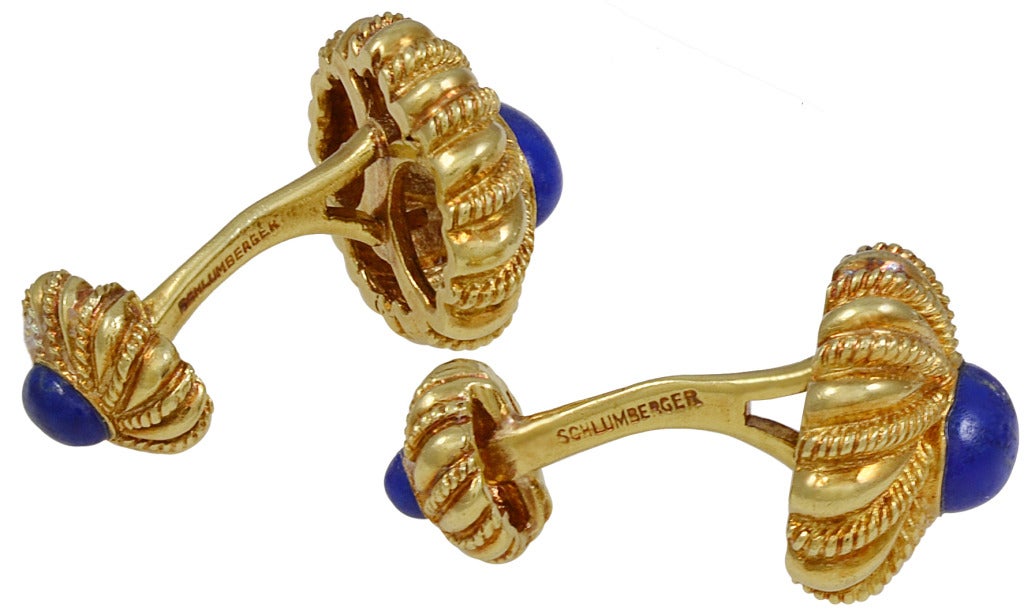 Polished and elegant swirl pattern cufflinks made  by 
Schlumberger, Tiffany& Co. 18K gold with large lapis center stone. The back of the cufflink is a smaller version of the front. Easy to put on.
Excellent for day or evening.