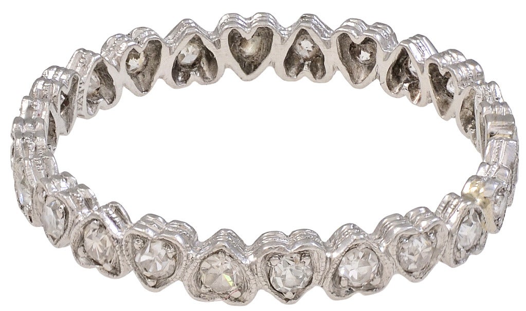 Delicate, feminine diamond heart eternity ring set in 14K white gold. Each heart is set with a full cut faceted diamond. 0.72tw of diamonds.Size 8 1/2. This ring can easily compliment any ring or simply be worn on its own. A romantic ring for a