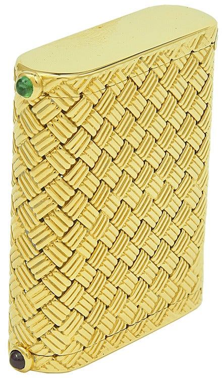 Woven basket weave pattern gold pill box, made and signed by Cartier. One compartment has a hinged closure set with a cabochon emerald; the other compartment is set with a cabochon ruby. Made in the 1940's,14k yellow gold.
Unique, sleek and elegant.