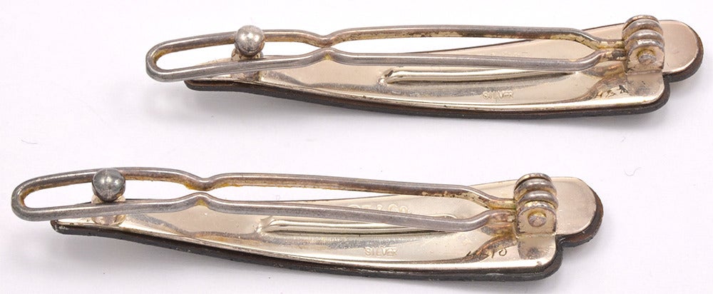 Lovely rare and unusual pair of barrettes by TIFFANY&CO. Made of sterling silver, steel and gold. Unique shape. Champagne bubble design. Perfect  for welcoming in the New Year.