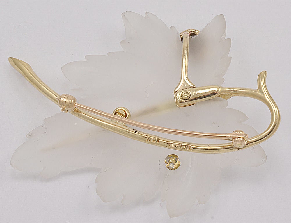 Beautifully designed carved crystal  figural leaf pin by Tiffany. Set with enamel lady bug and a full cut diamond. 14k gold.A  most graceful and appealing piece of jewelry.