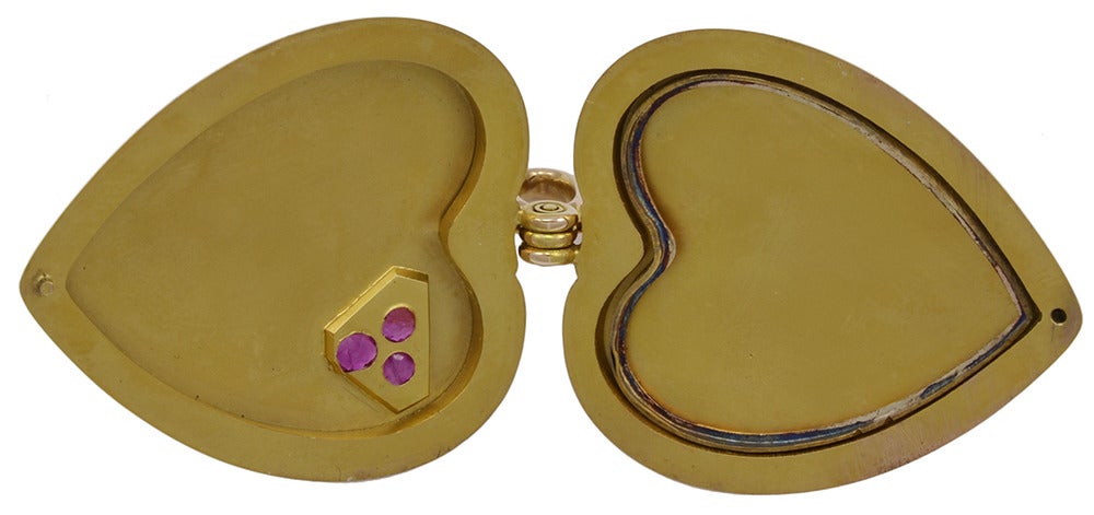 Outstanding antique large figural heart shaped double locket. Set with three exceptional faceted rubies. 1 3/4"x 1 1/3". 15K yellow gold English circa 1900.