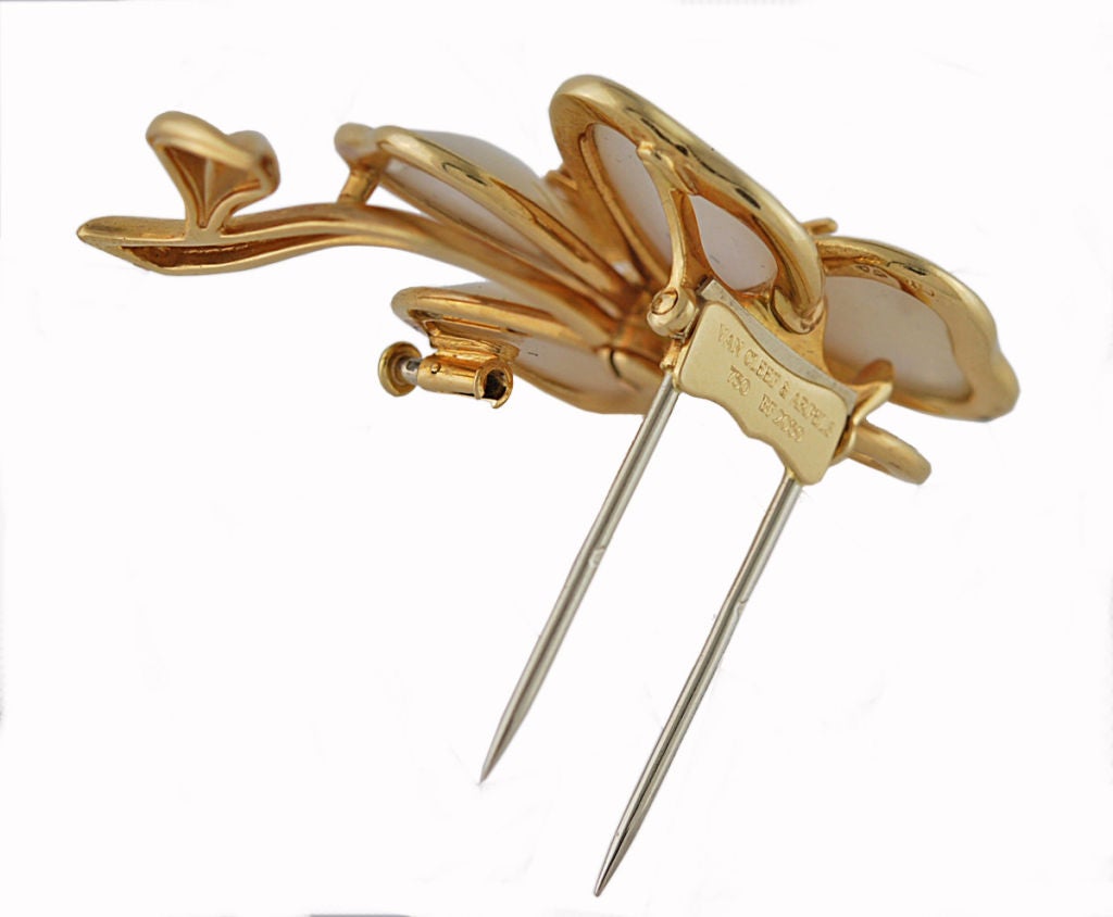 Van Cleef and Arpel 18K, mother of pearl and diamond flower clip.This exact pin is no longer made.<br />
Very brilliant <br />
 2