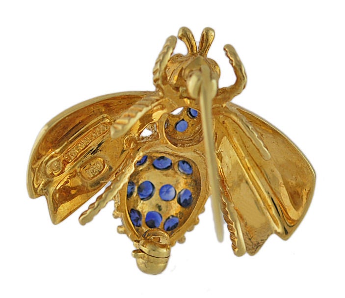 Vibrant Tiffany 18k gold bee pin.<br />
Ruby eyes,body. set with bright faceted sapphires and a full cut diamond.<br />
1 1/4