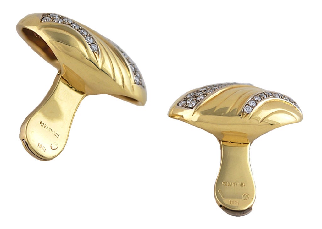 Uniquely designed large 18K ear clips, set with 3 double rows of diamonds.Set in swirl motif. Very bold and important looking.