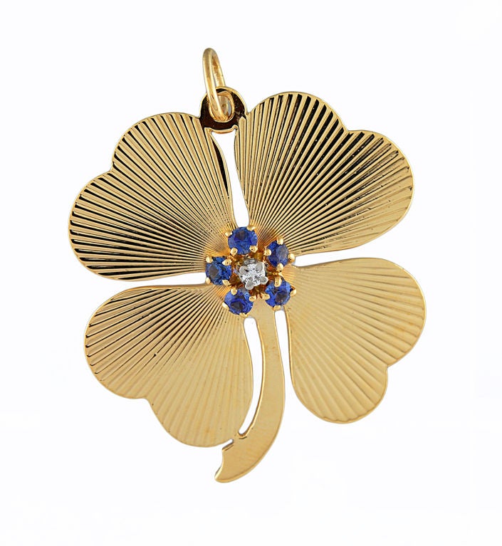 Tiffany 14k gold clover drop, with four heart shaped leaves.<br />
Set with faceted sapphires and center diamond.<br />
Inscription on back, 'Dec 25, 1958.'<br />
For LUCK AND LOVE!!