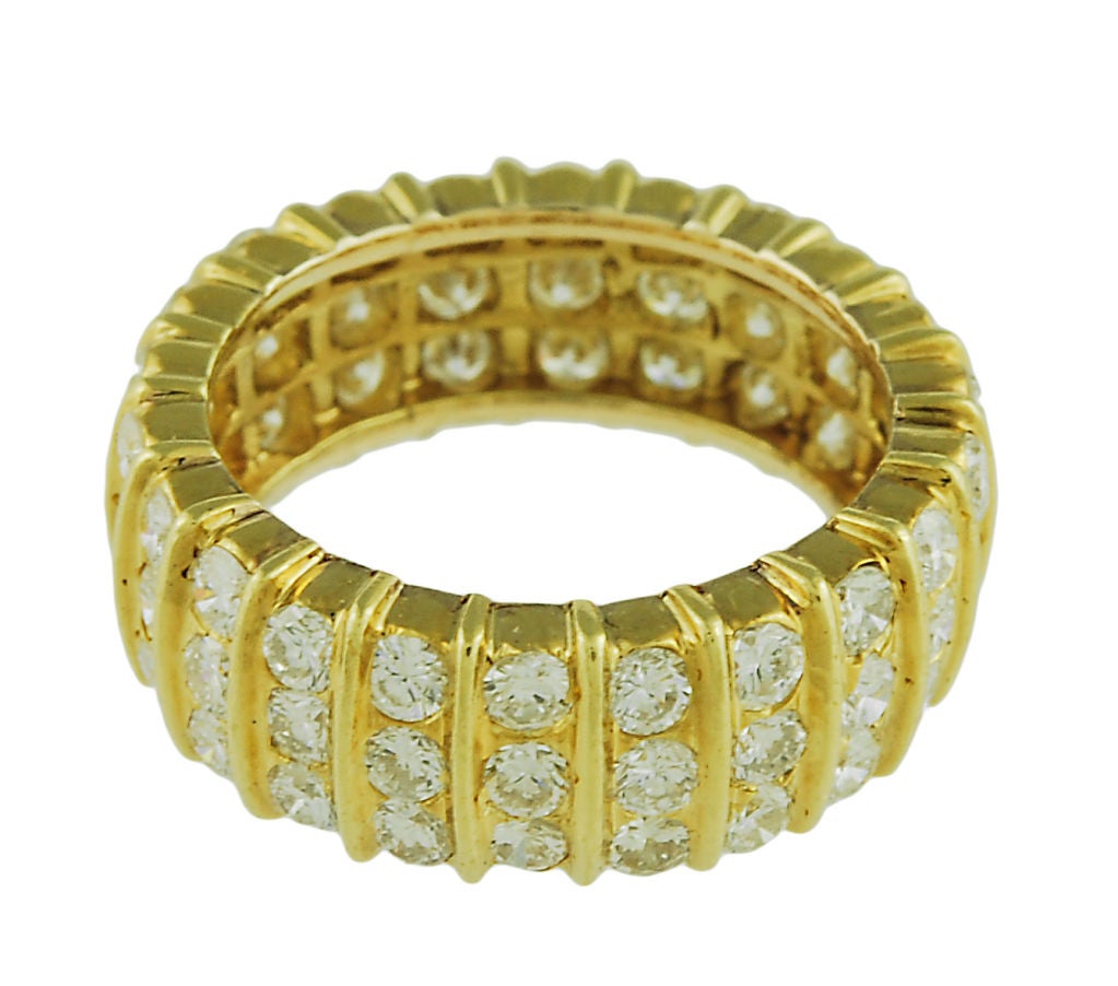 Sparkling 18K yellow gold and diamond eternity ring. Total weight 3.50 cts. Size 5.  Exceptionally brilliant.