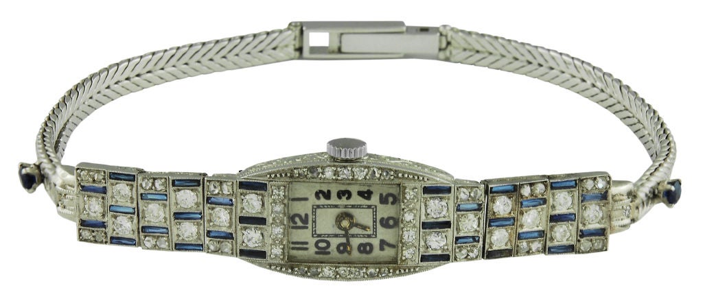 Art Deco platinum, diamond and sapphire watch.Interesting alternating pattern of diamond and sapphires.<br />
8 1/2