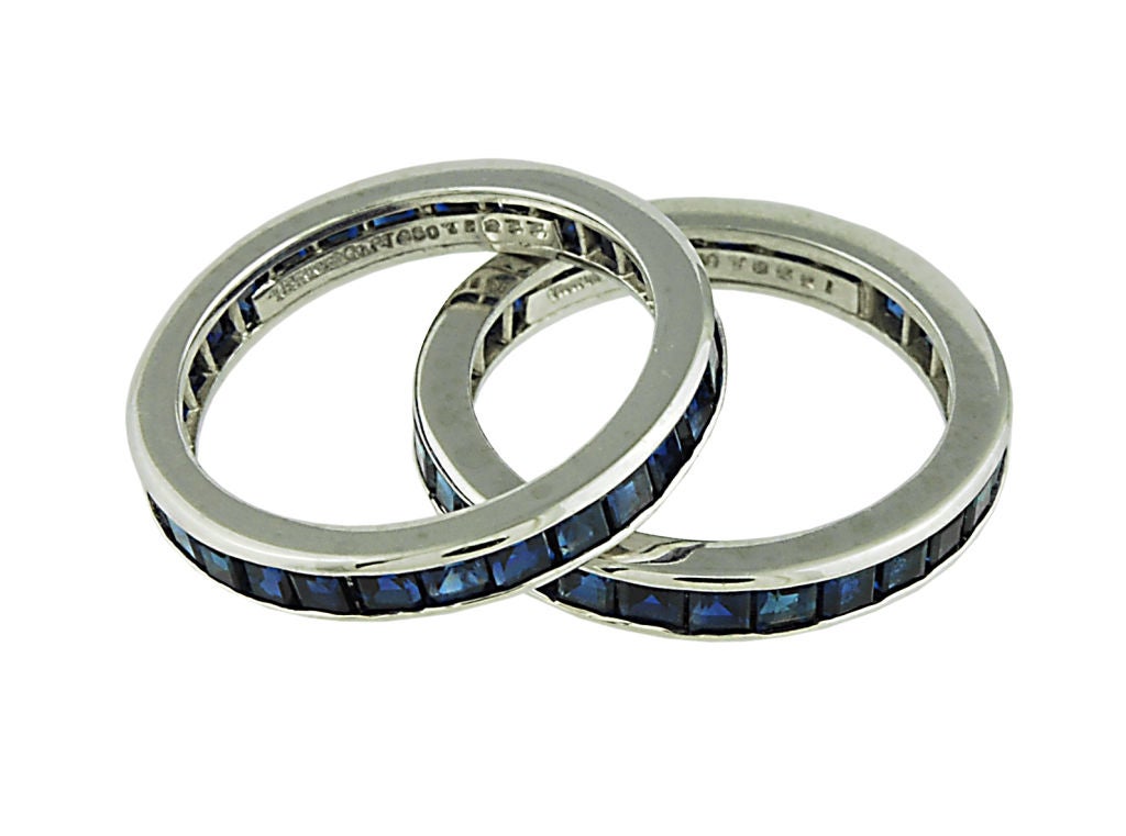 Tiffany pair of Sapphire eternity bands set in platinum.<br />
The sapphires are all channel set and are a beautiful rich matching color .<br />
Size 6