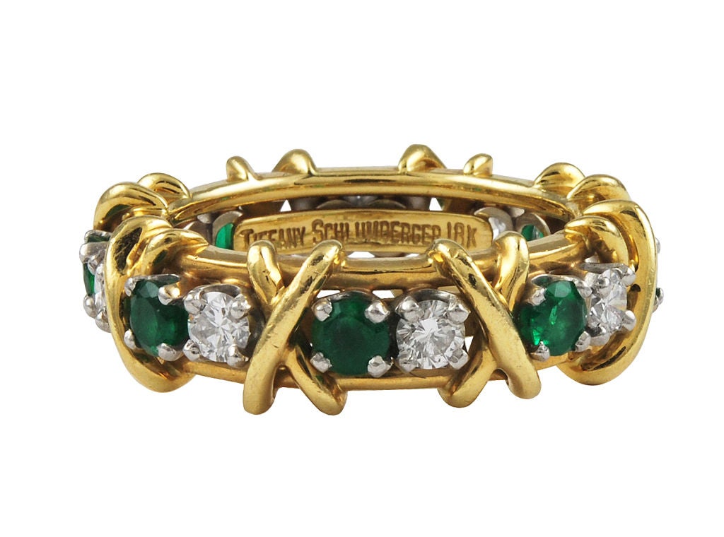 The classic sixteen stone eternity ring; TIFFANY SCHLUMBERGER,18k gold.
Set with faceted diamonds and emeralds.
Especially desirable, since this ring is no longer made with emeralds.