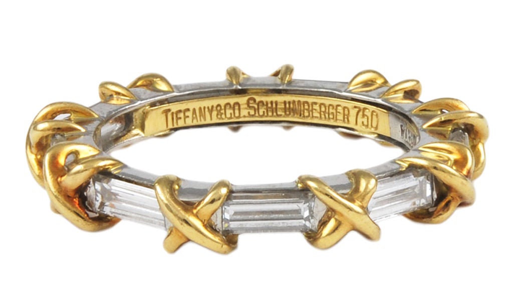 Tiffany Schlumberger platinum and 18K gold eternity band. All around baguette cut diamonds interspersed  with diamonds and yellow gold x's. A classic ring you never see. Size 5