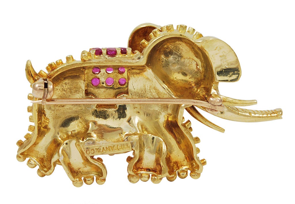Most beautiful and endearing elephant brooch by Tiffany&Co. Textured 18k gold; superb coloring,decorated with brilliant rubies; ruby eye.The MOST CHARMING ELEPHANT EVER!!!
