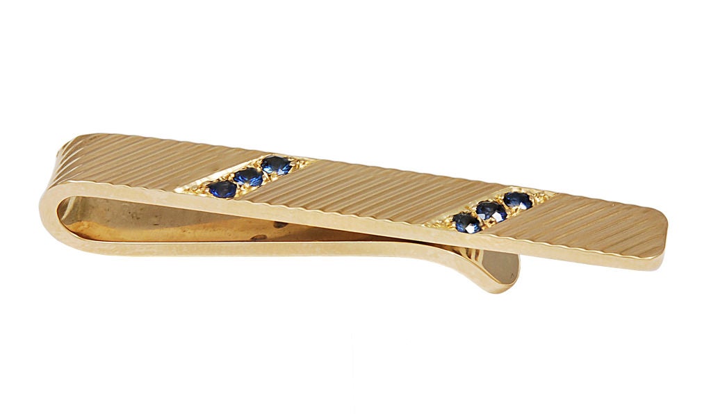 CARTIER 14K gold tie bar signed and numbered. Set with 6 faceted sapphires. A handsome look for a handsome guy!