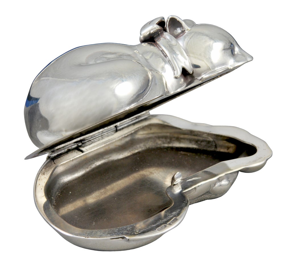 Charming sterling silver hinged figural cat  pill box. Made and signed by Judith Leiber in 2000.  The cat has a bow around his neck and is taking a nap. .Measures 2 1/2