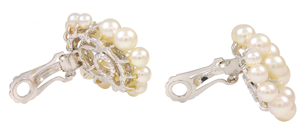 Large and impressive Diamond and Pearl Ear clips set in 14K white gold.Brilliant super white full cut diamonds set off by luscious lustrous pearls. Unique graceful design. These are exceptional