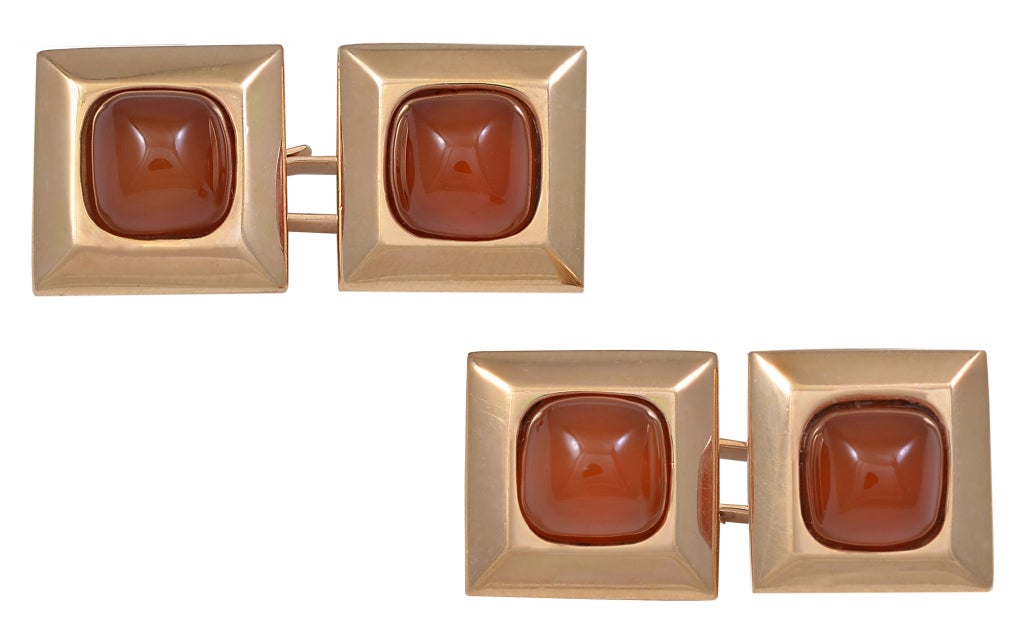Very handsome 14K gold double-sided carnelian cufflinks. These look three dimensional, with the gold beveled base set with sugar loaf carnelians.Strong, bold look. Great tawny color. Exceptionally well made. Beautiful construction.
