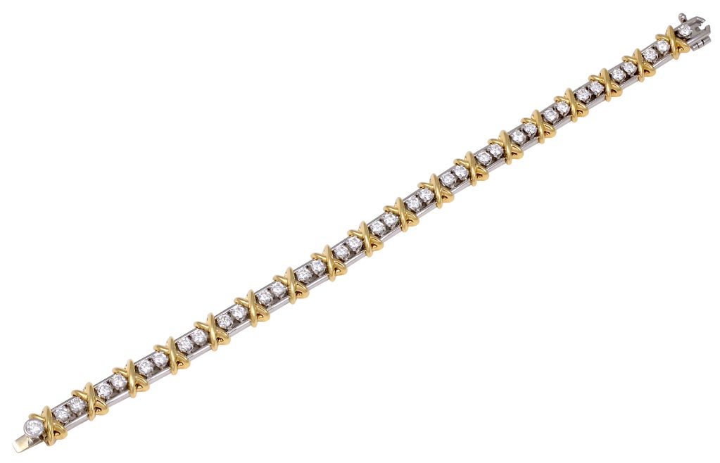 TIFFANY SCHLUMBERGER 36 stone Bracelet. Beautiful diamond bracelet, signed Tiffany&Co Schlumberger. Brillant cut round diamonds 2.95cts set in platinum and 18k gold, interspersed with gold x's. Classic Tiffany bracelet that stands alone or looks