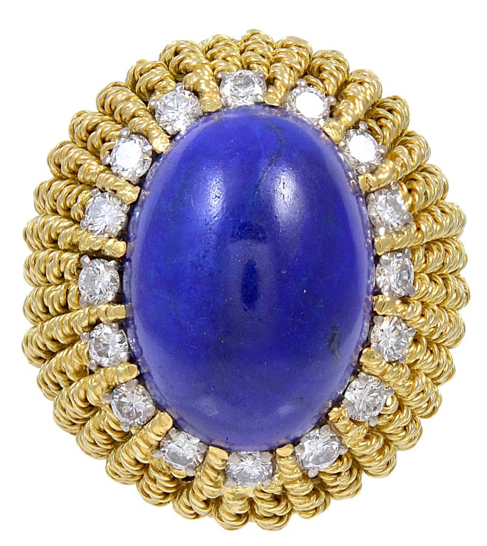 Large dramatic 18k gold lapis and diamond cocktail ring, Shank set with twisted rope motif. The lapis has a wonderful luster and weighs approz 37cts.
Size 7 and may be sized