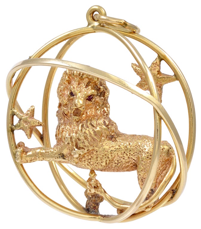 Large impressive 14K gold charm/pendant, made and signed by Ruser.  Textured three-dimensional body, set with faceted ruby eyes, surrounded by three stars.  This lion is powerful and full of confidence. For the Leo who is the center of the universe.