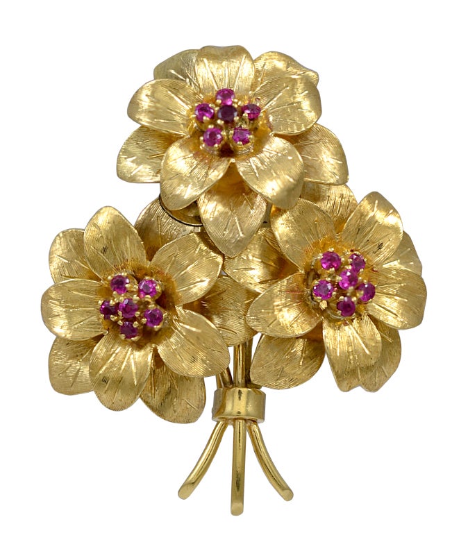 Very feminine and lovely 18k gold ear clips and brooch signed TIFFANY & CO. Graceful flower clusters set with bright faceted rubies.Will sell separately