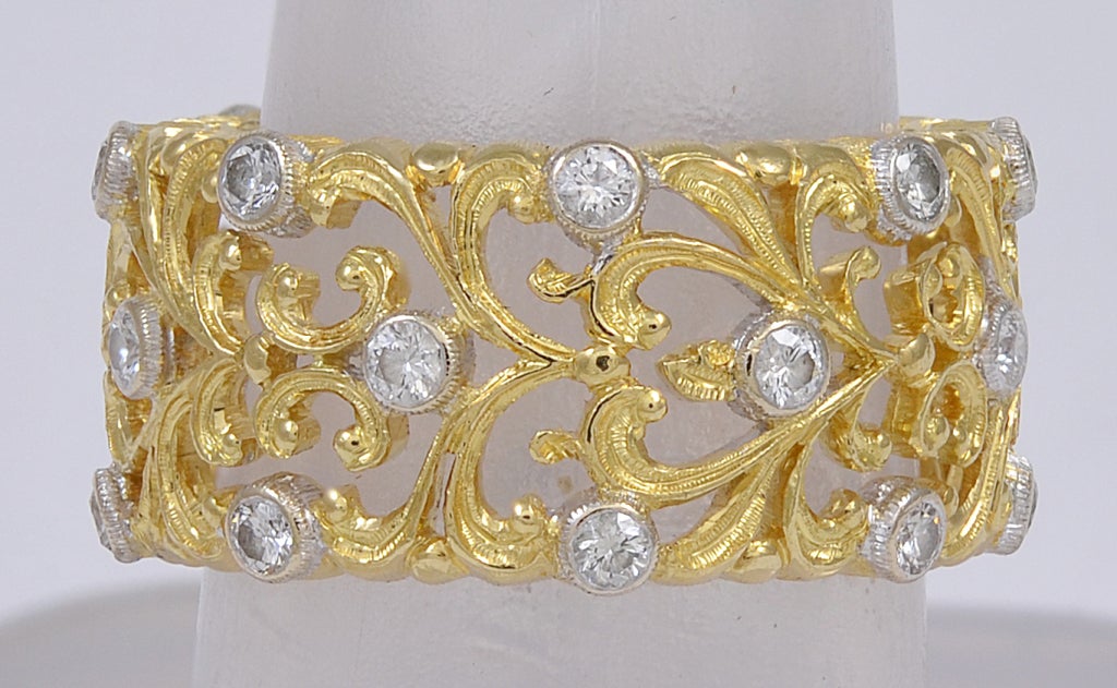 Sparkling 18k yellow gold wide eternity band set with brilliant with diamonds
made and signed by Buccellati.
All over fine cut-out lacey pattern. Size 5 3/4 
A great Buccellati look.