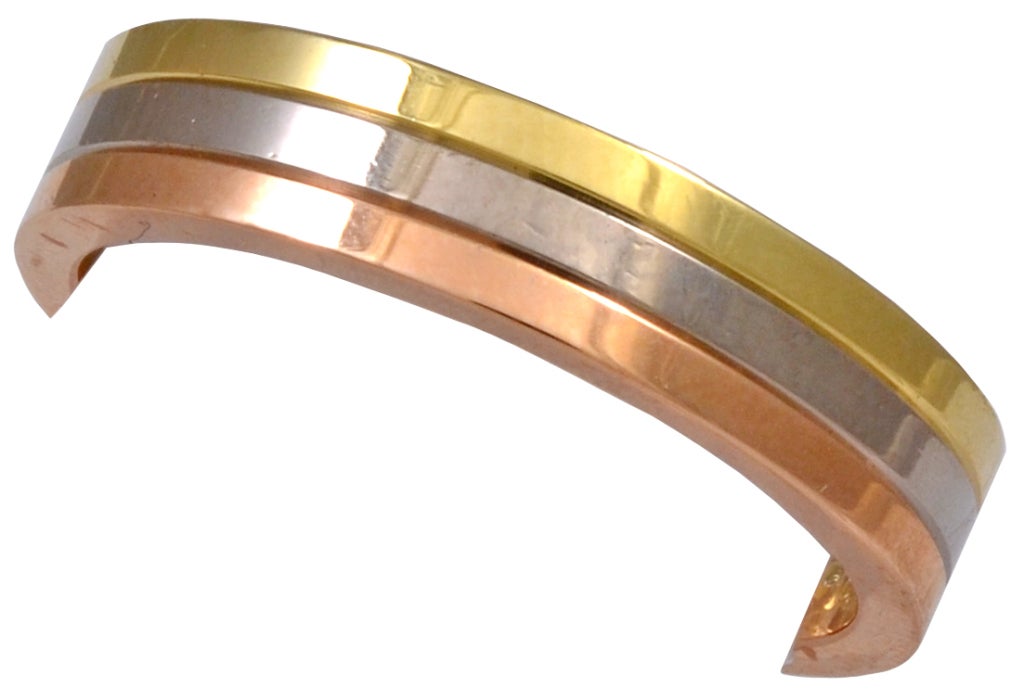 Sleek CARTIER tri-color 18k gold band. Signed and numbered.
Size 8 1/2. Classic tailored look!