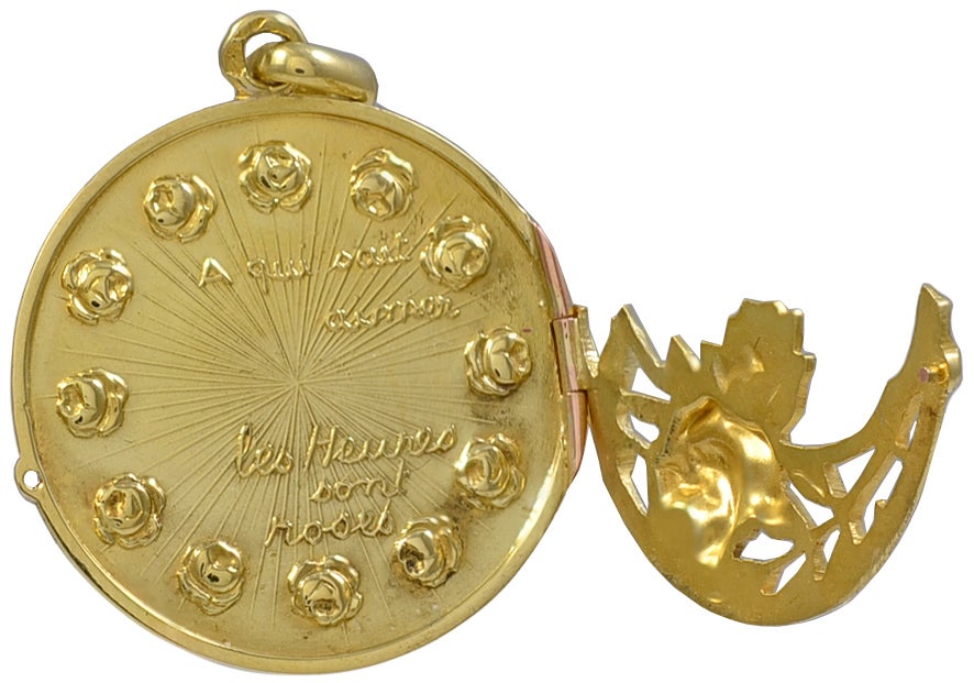 Most endearing and lovely French charm, 18K gold, decorated with applied rosettes.  Top part of the message, in French, reads 