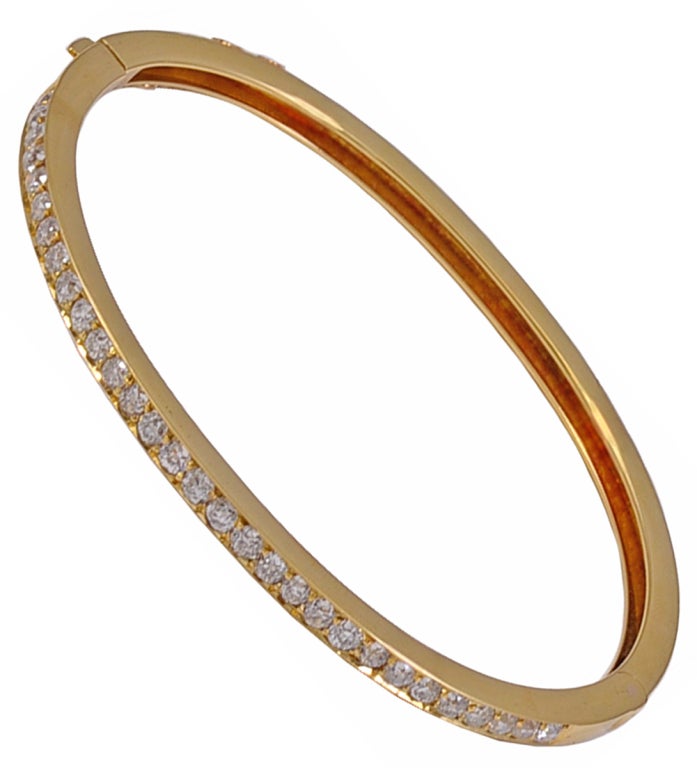 Beautiful antique sparkling 18K gold and diamond bangle bracelet, made and signed by Tiffany&Co. Top half of bracelet is set with 3.0cts of extra brilliant full-cut diamonds. This bracelet is antique and so classic that it may be combined with