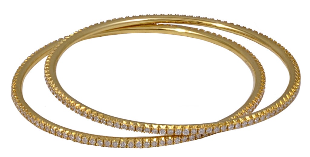 Lovely pair of diamond bangle bracelets. Made and signed by Tiffany & Co. 
