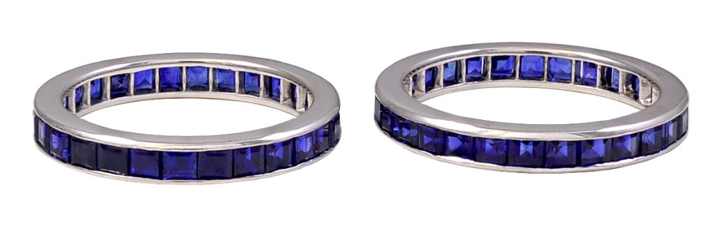 Beautiful pair of square-cut sapphire eternity bands, set in platinum. Made and signed by Tiffany & Co. Extremely well matched stones. Size 6 3/4.Most unusual to find a pair