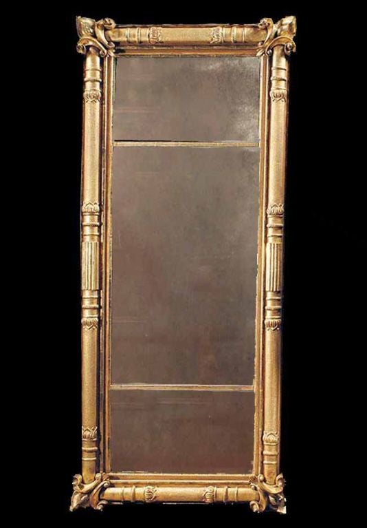 # E517 - A handsome American Empire carved and gilt overmantel mirror. During this early 19th century in America, the mirrors tended to parallel the designs created in France during the Empire period. The stronger classical motifs replaced the