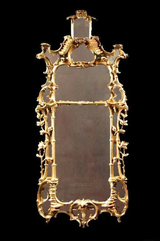 # G349 George III carved and giltwood mirror in the Rococo taste.  Note the fluid and well balanced design achieved by this very expert and artistic carver. The large central divided rectangular plate surrounded by an artistic arrangement of “C” and