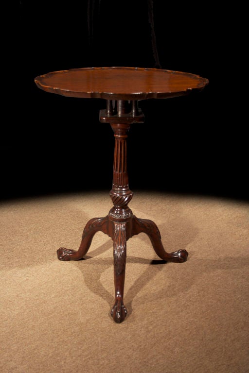 # T084 - Mid-Georgian mahogany tilt top piecrust table having a lovely color and graining. The well carved piecrust top above a birdcage and raised on a fluted and tripod cabriole legs carved at the knee with acanthus leaves and ending in carved