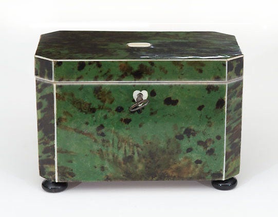 A Rare Late 18th c. English Green Tortoiseshell Tea Caddy with canted corners, its original lock and key, accented with bone stringing, a heart-shaped bone escutcheon, and featuring two foil-lined interior compartments to keep the tea fresh, one for