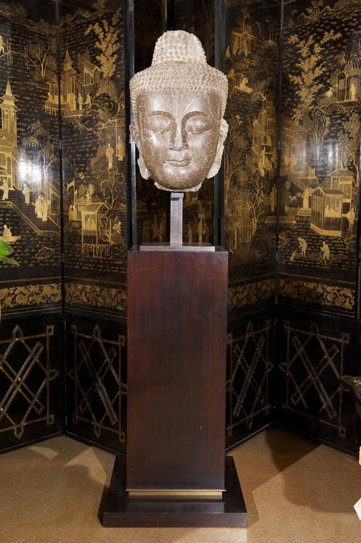 A rare and monumental 5th century Burmese temple colossus head of Siddhartha Gautama Buddha, executed in variegated marble and presented on a bronze and mahogany pedestal.