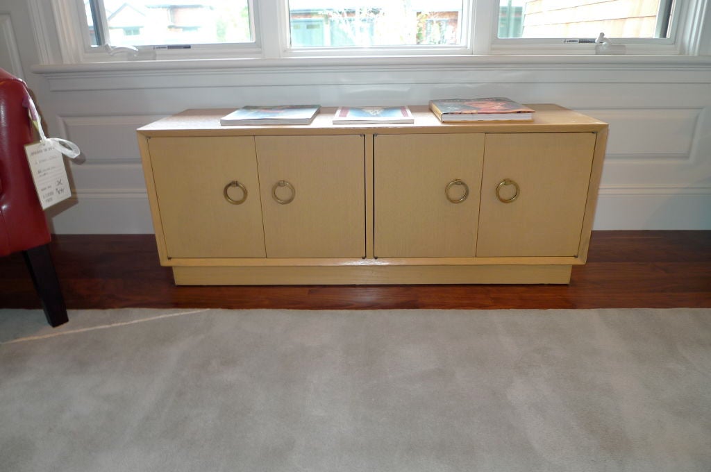 Pair of four-door credenzas by T. H. Robsjohn-Gibbings for Widdicomb with Gibbings signature brass ring handles.<br />
<br />
Price is for the pair. <br />
<br />
Also available is matching pair of low book shelves.