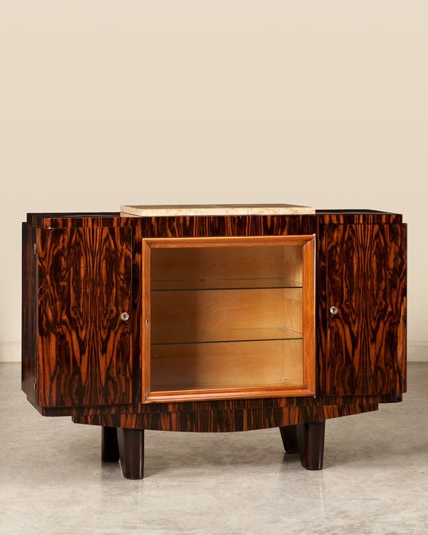 A striking Art Deco period display cabinet/buffet most probably designed and executed by Jean Fauré from Toulouse, France 1936-1940. Please notice the extravagant use of Macassar ebony with its bold pattern in the grain. The ebony is featured across