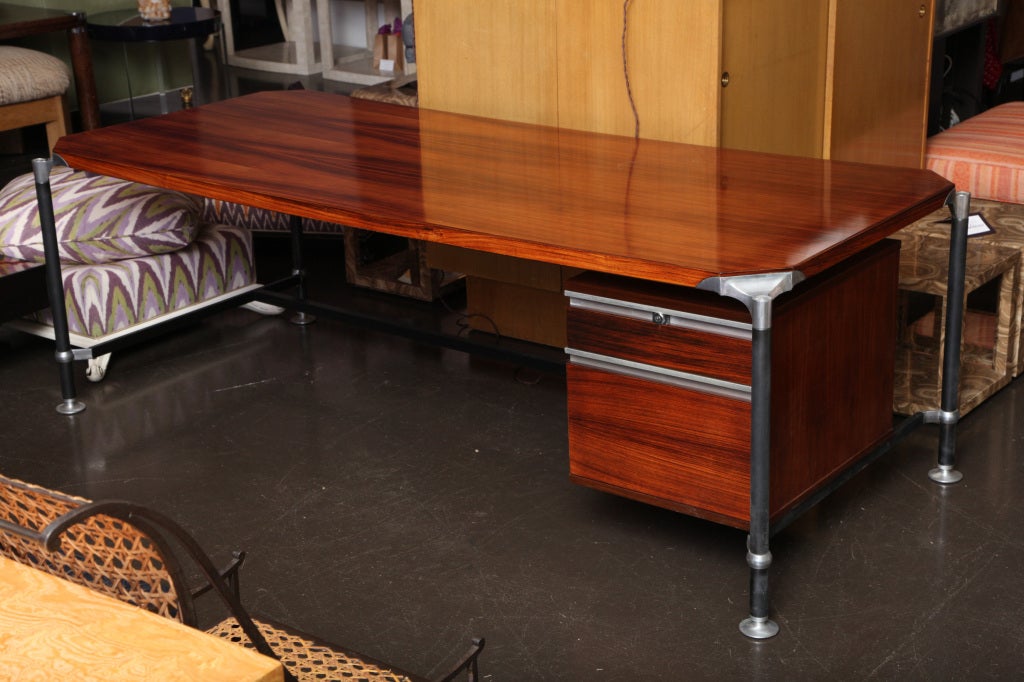 Fabulous desk with beautiful rosewood top, nickel details, and enameled steel legs and stretcher. With two drawers, one large for files and one small. Expansive surface is a great work space!