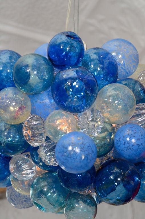 Vintage hand blown glass balls of varying sizes clustered around light bulbs