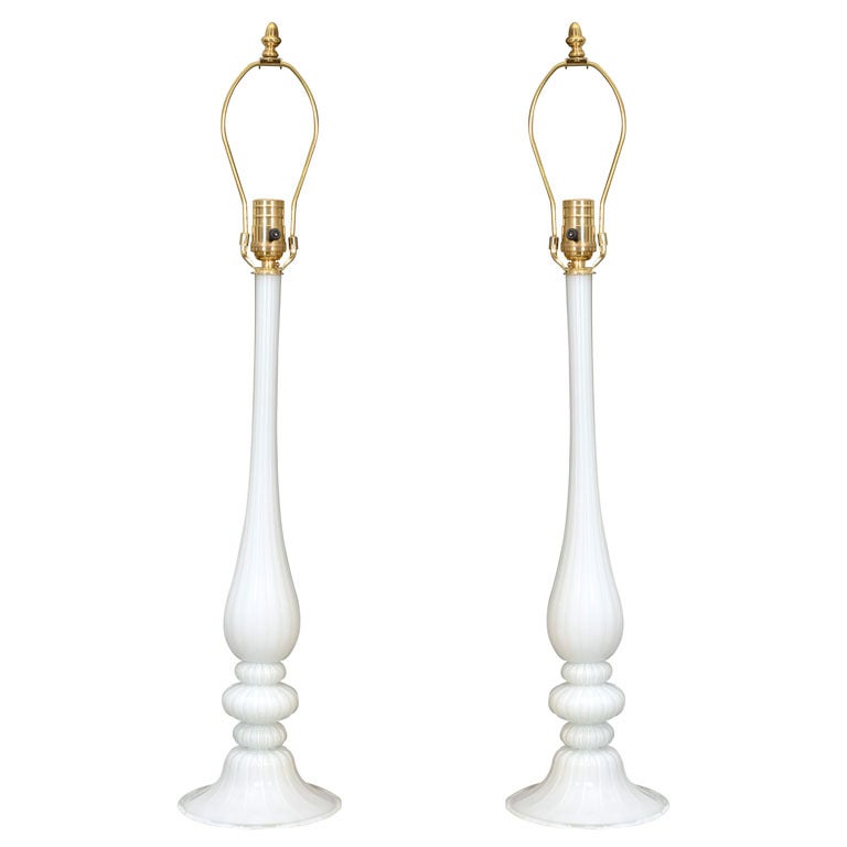 Absolutely beautiful and so very delicate, this pair of murano glass lamps would be a distinctive work of art in any decor. The base materials were made with quartz pebbles from the Ticino and Adige river beds in Italy. White on white, these lamps