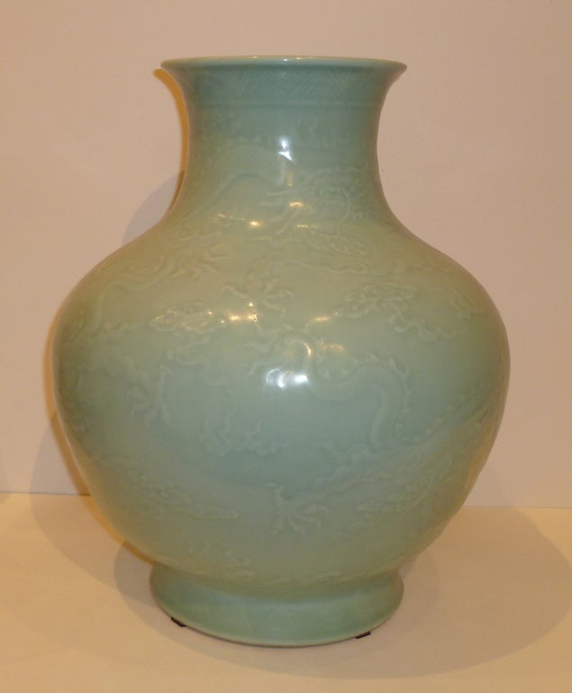A Pair of porcelain vases in celadon green with under glaze dragon amid in clouds motif. 11