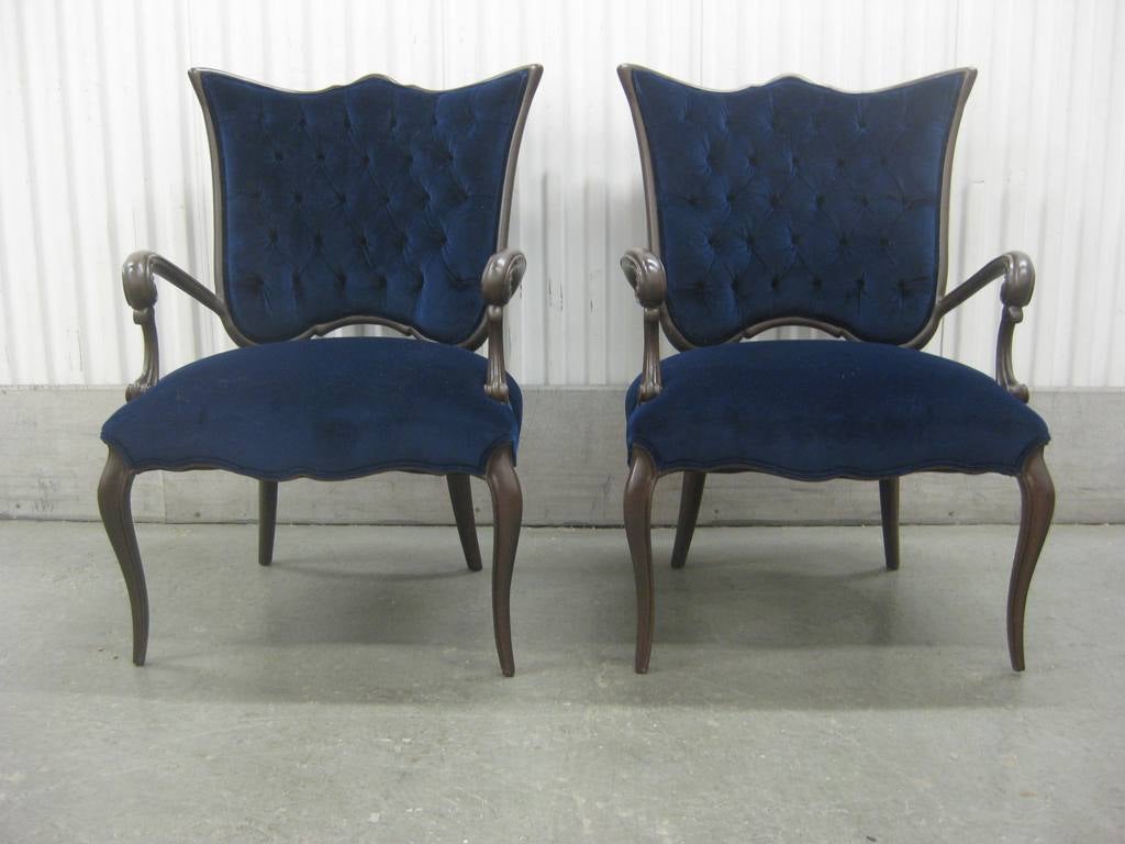 Pair of high style Italian Regency chairs newly restored and fully upholstered in button tufted blue velvet and chocolate Brown finish carved wood.