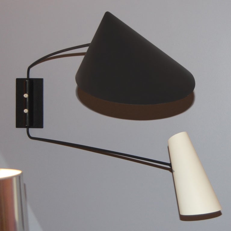 Important, adjustable, double branch wall lamp in black lacquered, tubular metal surmounted with folded sheet metal shades by Pierre Guariche, French Circa 1950.<br />
H : 49 2/3 L : 31 1/2 D : 8 in.