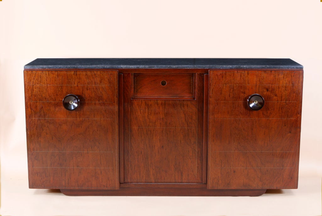 ANDRE SORNAY (1902-2000)

Mahogany cabinet with geometric cloutage work; two hinged doors and one sliding door with recessed drawer. Marble top. Signed.
France, 1930's